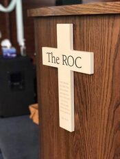 The ROC on a cross affixed to the podium